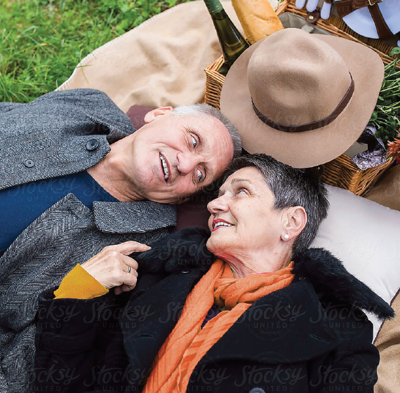 senior couple laying in the grass