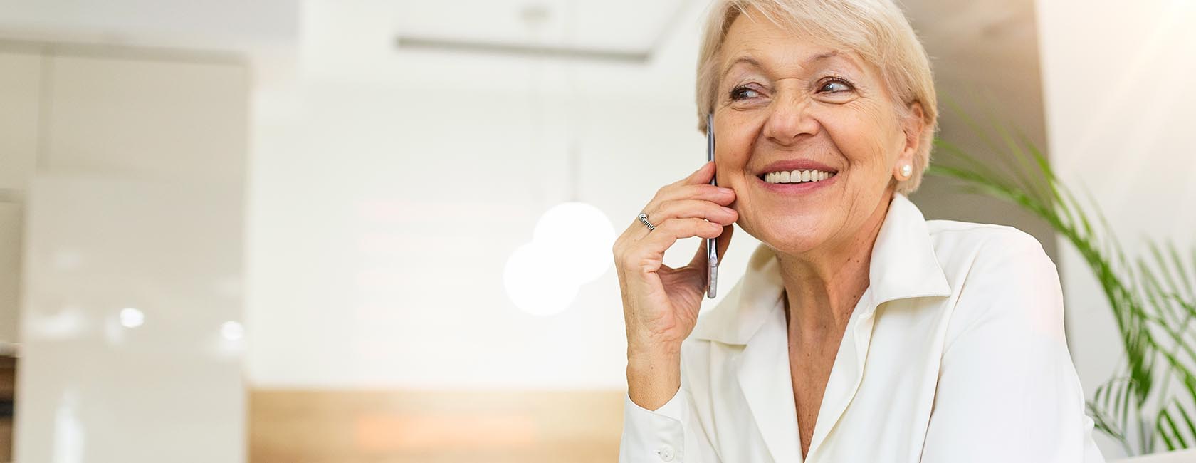 senior lady talking on a cell phone while smiling