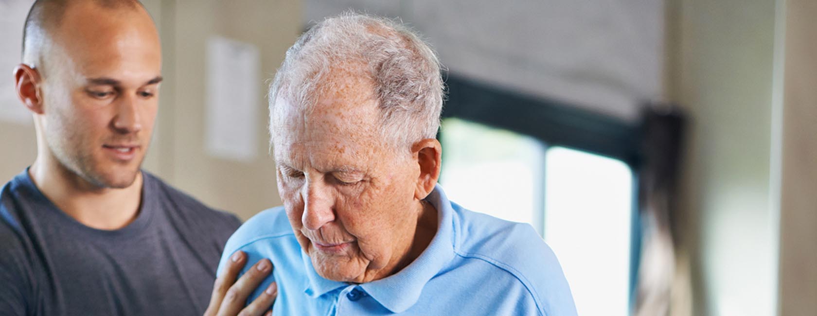 senior in senior rehabilitation getting assistance from a healthcare worker