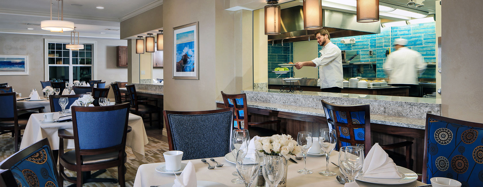 a chef serving a plate in Maplewood's dining room