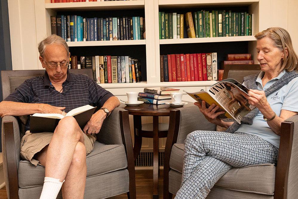 Senior couple reading in the library